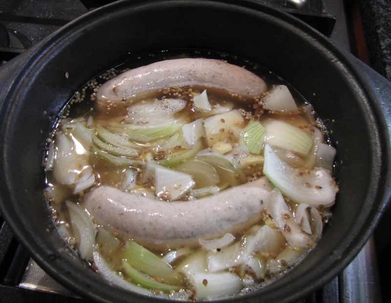 Bauernbratwurst cooking in brine